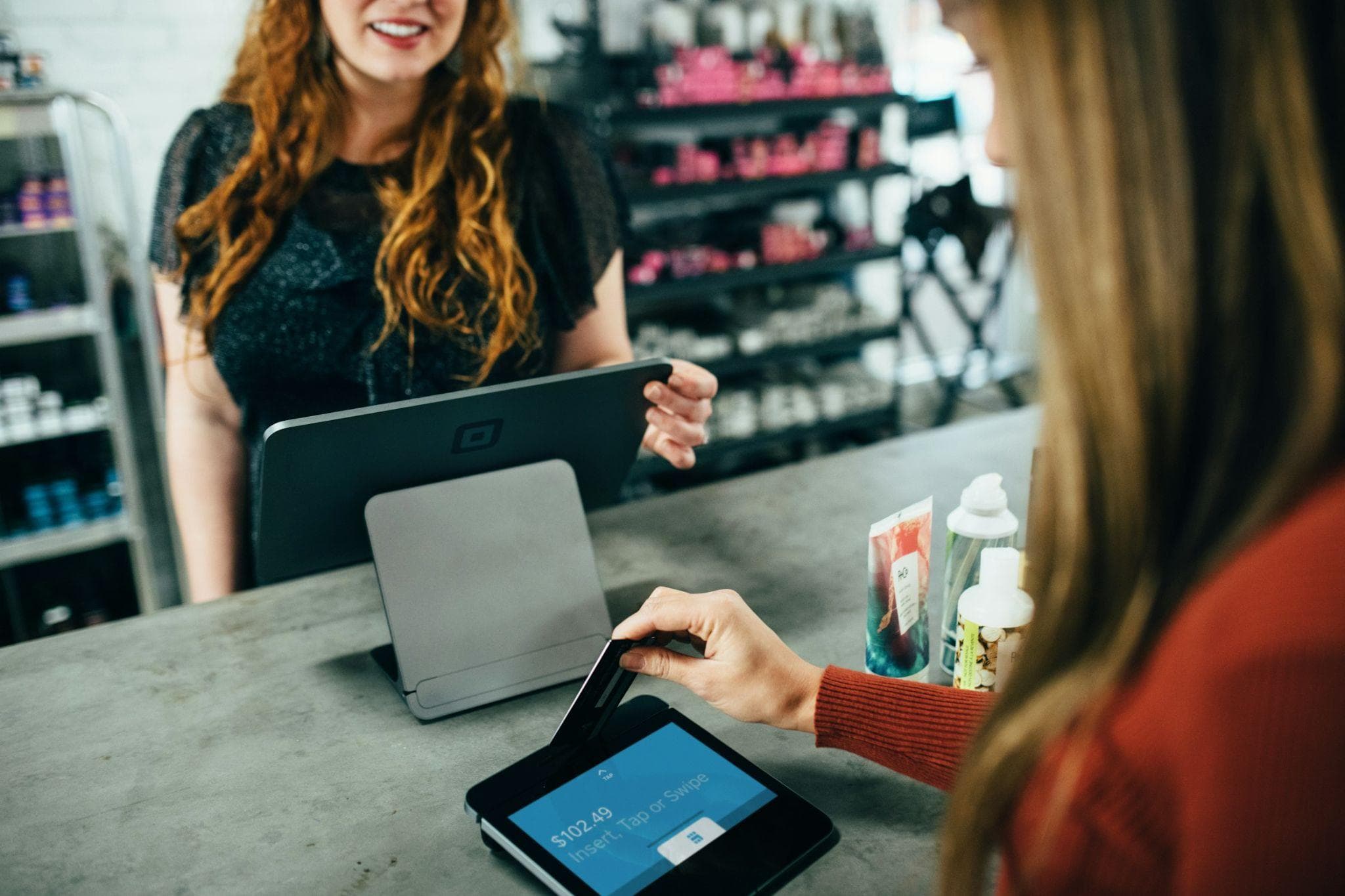 Shop owner taking a card payment at the counter